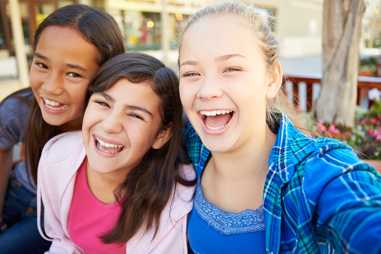 Group Of Girls Hanging Out In Mall Together Smiling And laughing